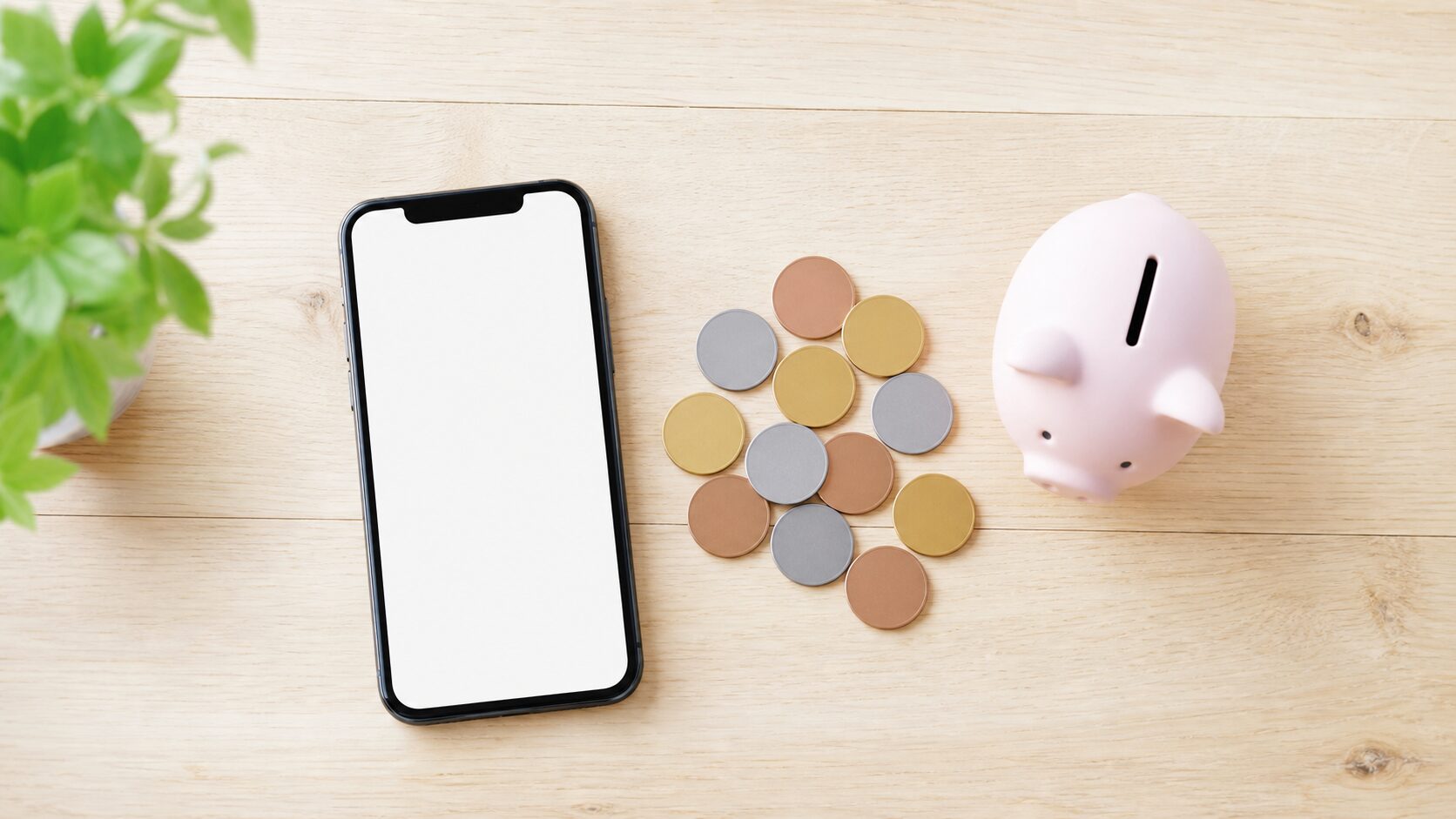 スマホと小銭を並べた通信費節約のイメージ